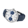 The IWC Schaffhausen Portugieser Automatic features a silver case, white dial with blue hour markers, subdials, a date at 6 o’clock, and a blue alligator leather strap.