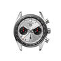 The TAG Heuer Carrera Chronograph features a silver case, two black subdials, and a date window at 6 o’clock.