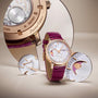 The Vacheron Constantin Traditionnelle Moon Phase wristwatch, featuring a purple leather strap and pink gold case, is shown with its limited edition caseback reflected in a mirror and magnified moon phase details on the decorative dial.
