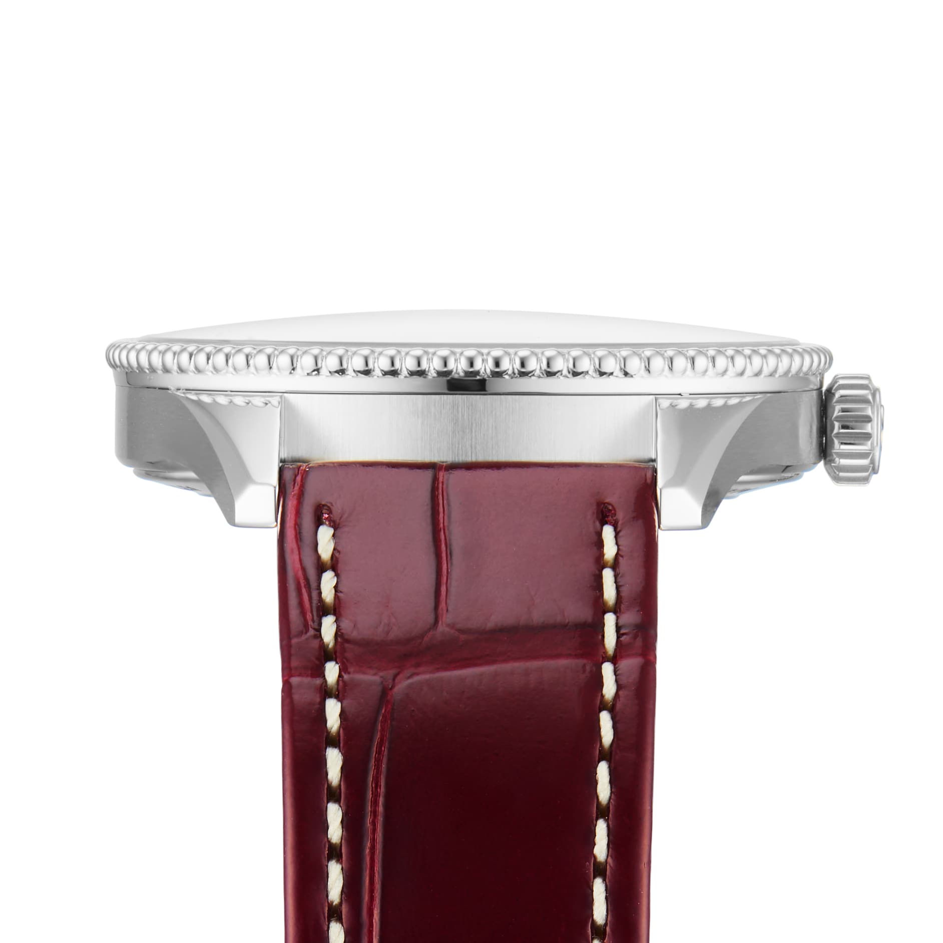 Side view of the Breitling Navitimer 32, featuring a silver case, textured bezel edge, and brown leather strap with white stitching, powered by the precise Breitling Calibre 77 SuperQuartz™ movement.