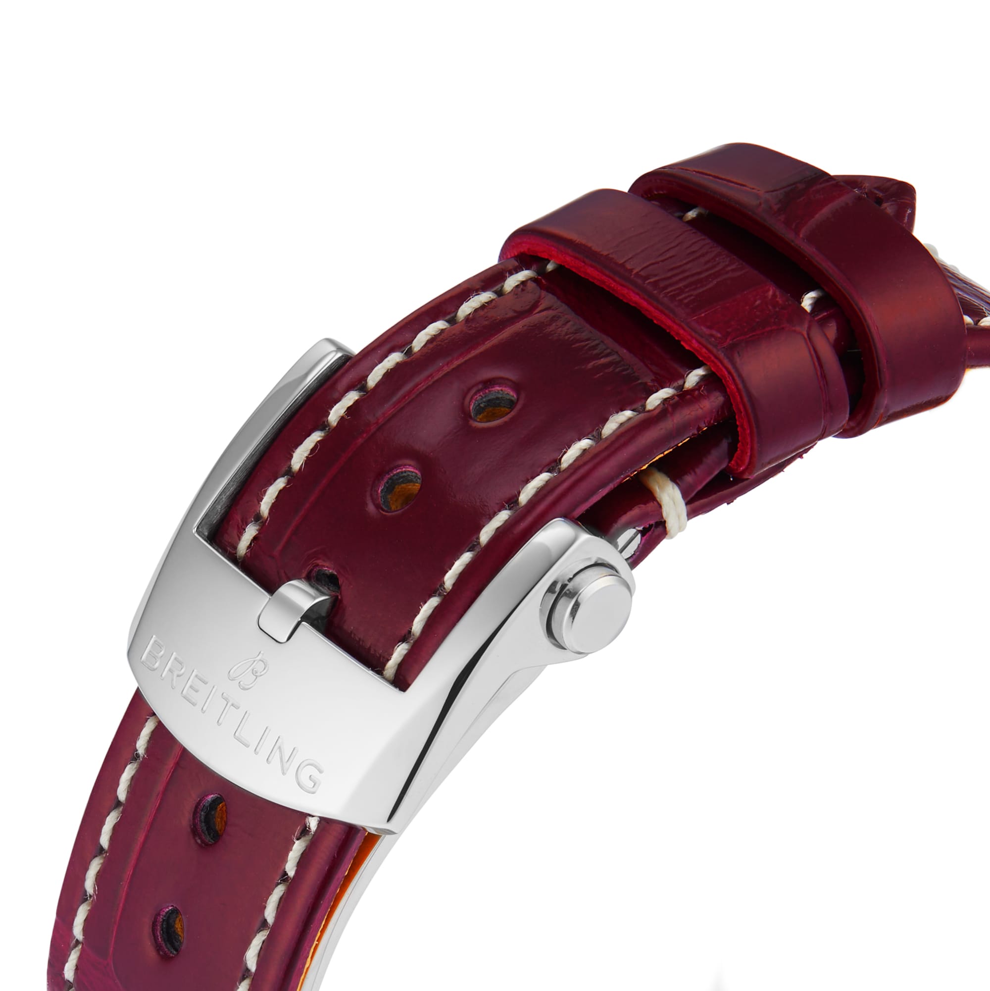 Close-up of a red leather Breitling Navitimer 32 watch strap featuring white stitching and a silver clasp embossed with the Breitling logo.