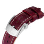 Close-up of a red leather Breitling Navitimer 32 watch strap featuring white stitching and a silver clasp embossed with the Breitling logo.