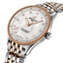 The Breitling Navitimer 32 features a white dial, gold hour markers, diamond indices, SuperQuartz™ movement, and a two-tone metal bracelet.