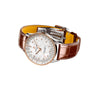 The Breitling Navitimer Automatic 36 features a brown leather strap, silver and rose gold case, white dial, and diamond hour markers.