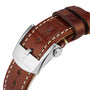 Brown leather strap with white stitching and a silver clasp engraved with Breitling, designed for the Navitimer Automatic 36.